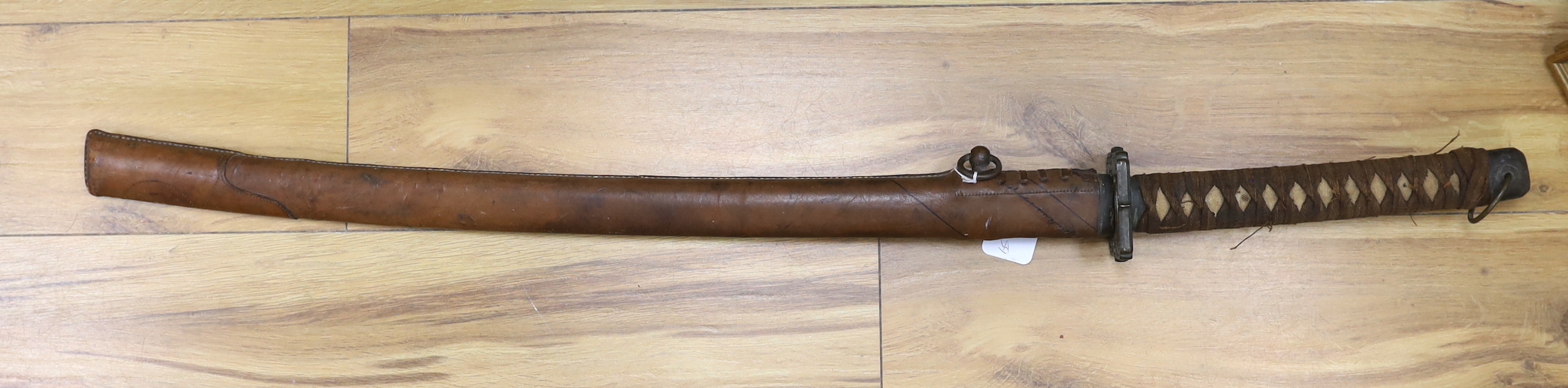 A Japanese WWII Shin gunto (sword) and leather mounted scabbard